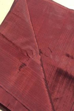 Meters of handloomed silk in a Burgandy colour. Fine weave, use for clothes and furnishing